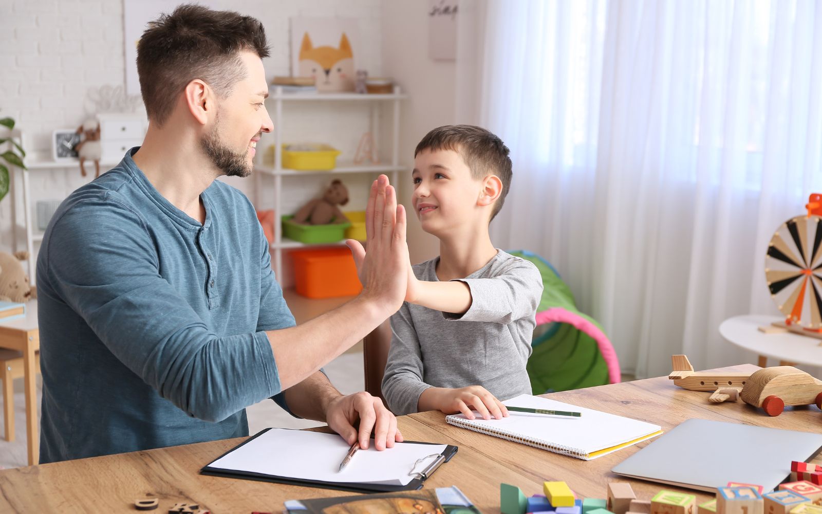 A clinician reviewing a Child Behavior Checklist (CBCL) form with parents, highlighting its use in assessing a child's emotional and behavioral health.